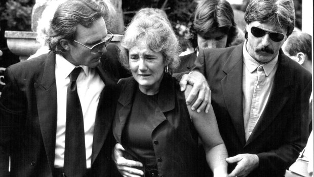 Peter and Christine Simpson are supported by friends and family as they leave the Bowral local court in 1993. 