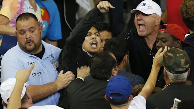 A man is removed as he protests Republican presidential candidate Donald Trump during a campaign rally in Orlando, Florida, earlier this month.