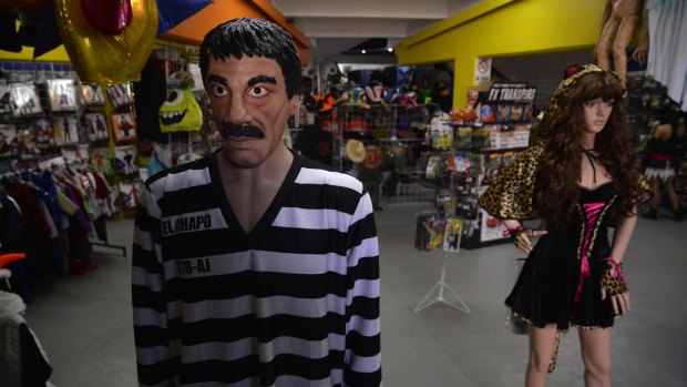 A striped prison jumper and detailed latex mask representing "El Chapo" at costume maker Caretas. Costume designer Hector Bustos said the costume idea began as a dark joke among colleagues but then they thought, 'Why not?'