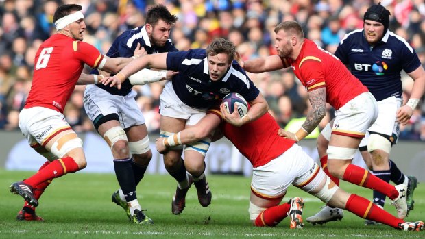 Scotland's Jonny Gray is brought to the ground.