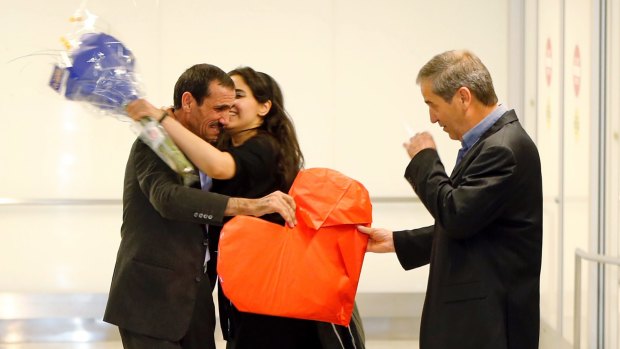 Ali Vayeghan is kissed by his niece Marjan Vayghan as his brother Houssein Vayghan watches.