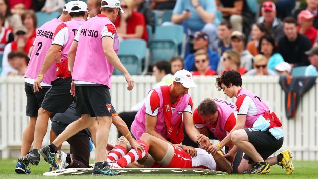 Quick attention: Swans trainers and medical staff tend to Franklin after the collision.