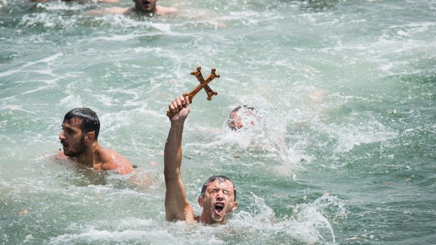 George Noulas 22, of Avondale Heights reaches the cross first at the annual Blessing of the Waters Festival.