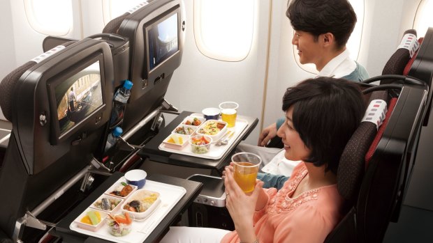 Passengers enjoy economy seating on Japan Airlines.