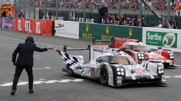Germany's Nico Hulkenberg in his Porsche 919 crosses the line to win the 83rd Le Mans 24 Hours endurance race.