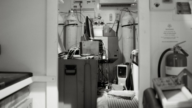 Scientists working in the mine's temporary lab operate in a confined space.