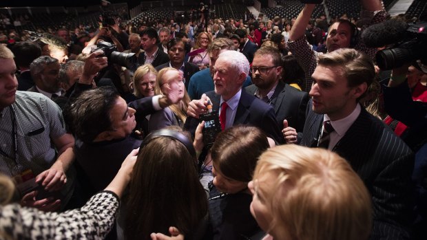 Jeremy Corbyn, leader of the UK opposition Labour Party, centre, is surrounded by members of the media.