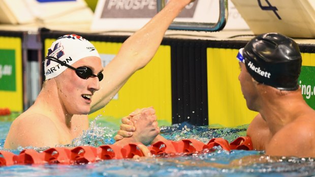 Mack Horton and Grant Hackett shake hands after the former's win in the 400m freestyle.