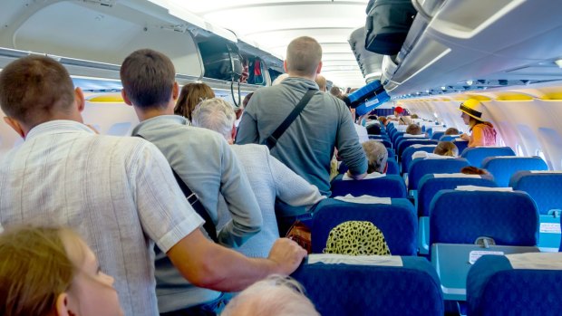 Despite being asked to remain in their seats while the rows in front disembark, passengers are still getting up as soon as seatbelt sign goes off.