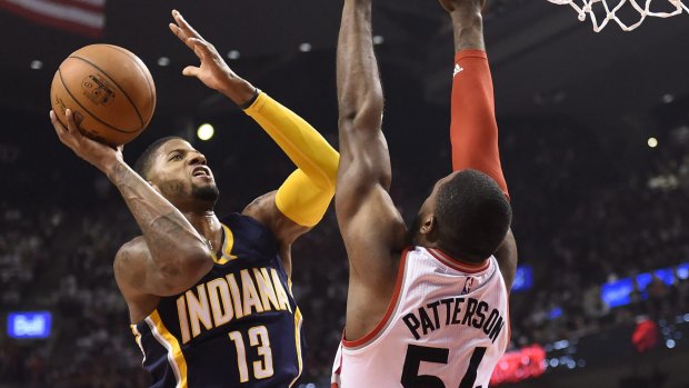 Hard to guard: Toronto Raptors forward Patrick Patterson defends as Indiana Pacers star Paul George drives to the net.