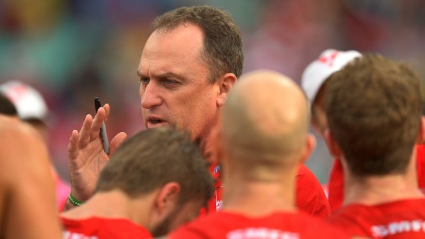 Swans coach John Longmire speaks to the players at half time during the round 20 match against Port Adelaide Power.