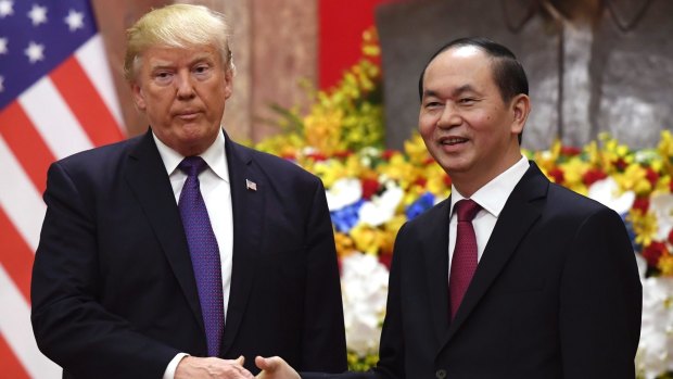 US President Donald Trump shakes hands with his Vietnamese counterpart Tran Dai Quang at the Presidential Palace in Hanoi.