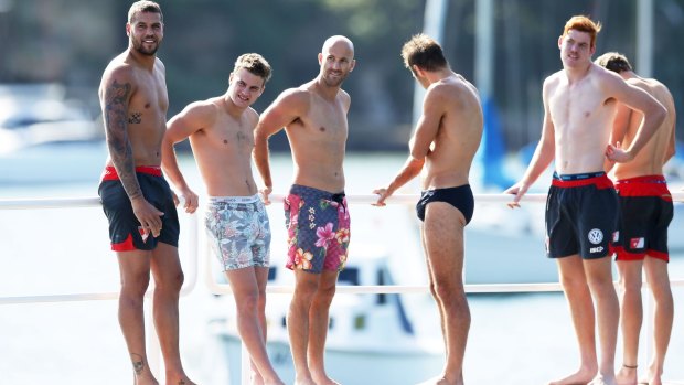 Sydney Swans players at a recovery session at Redleaf Beach on Monday.
