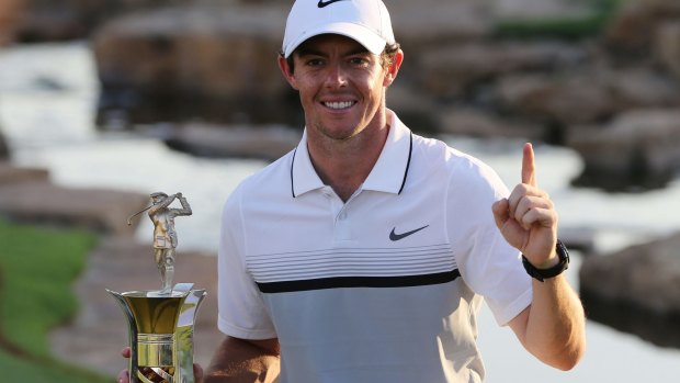 Seeing clearly: Rory McIlroy poses with the Race to Dubai trophy in November.