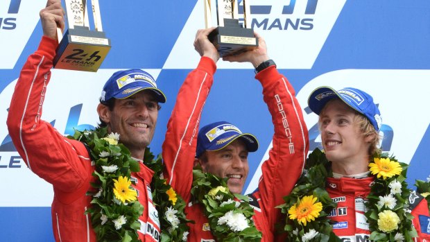 Australian Mark Webber, German Timo Bernhard and  New Zealander Brendon Hartley celebrate claiming second place at Le Mans for Porsche.