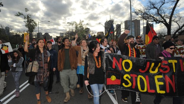 Protesters make their way across Princes Bridge.