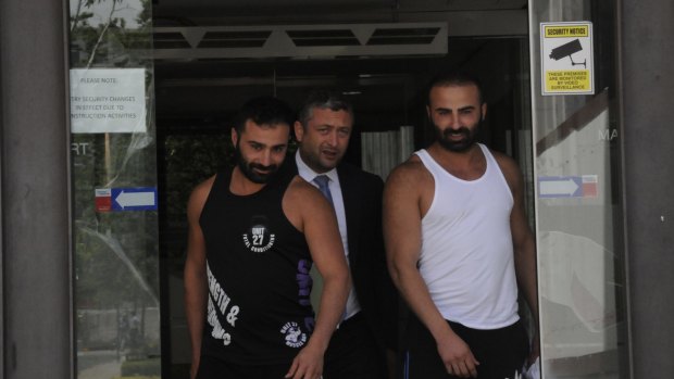 Adam Jabal (far left) and Youssef Jabal (far right) leave the ACT Magistrates Court on Tuesday with their lawyer Kamy Saeedi.