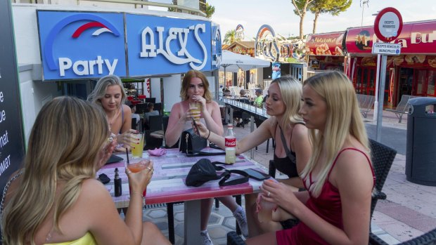 Tourists sit in a bar at the resort of Magaluf.