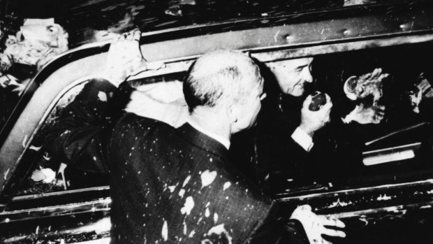US President Lyndon B. Johnson in his paint-splattered car in Melbourne in 1966.