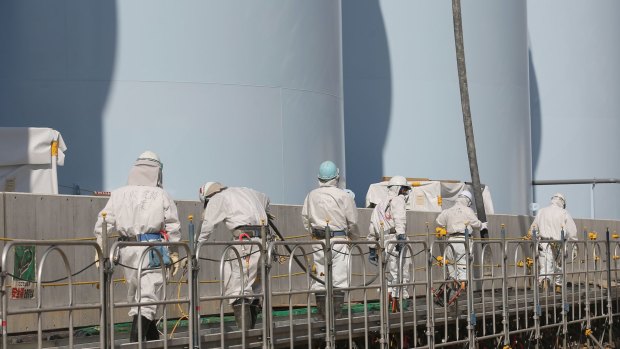 Workers work on new radiation-contaminated water tanks at Fukushima No.1 nuclear power plant. Five years after the nuclear disaster, 99,750 people still live as evacuees away from contaminated areas.