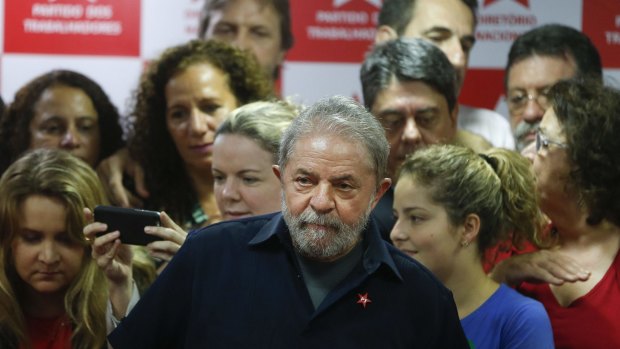 Brazil's former president Luiz Inacio Lula da Silva, centre, after being questioned in a snowballing corruption probe this month.