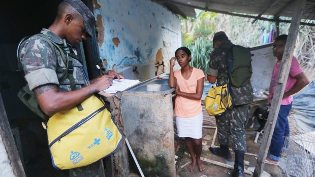 Brazilian soldiers inspect a home in an attempt to eradicate mosquito larvae.