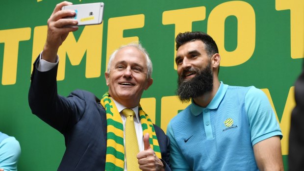 Prime Minister Malcolm Turnbull takes a selfie with Socceroos captain Mile Jedinak on Thursday. 