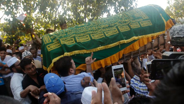 People carry the coffin of  Ko Ni to his final resting place.