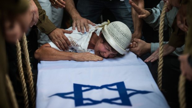 Amnesty report: The grandmother of Israeli soldier Jordan Bensimon at his funeral on July 22, 2014 in the southern Israeli city of Ashkelon.