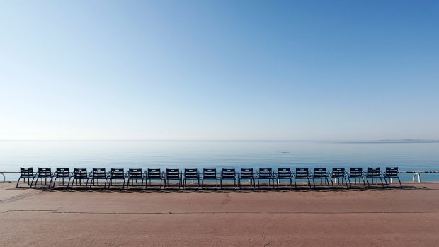 Empty chairs beside the beach on Promenade des Anglais avenue in Nice, France.