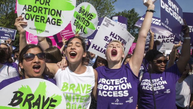 Abortion rights activists rejoice in front of the Supreme Court in Washington, Monday, June 27, 2016, as the justices struck down the strict Texas anti-abortion restriction law known as HB2. 