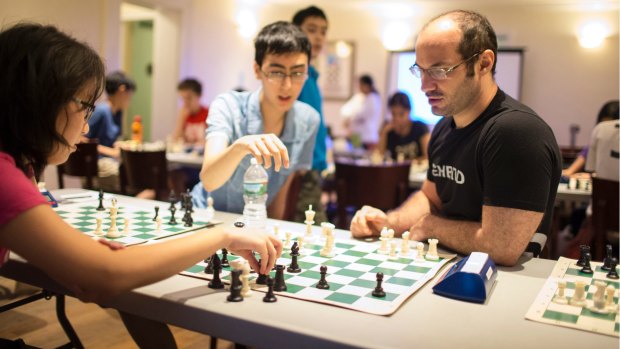 Greg Shahade, right, the instructor at the clinic at the Marshall Chess Club.