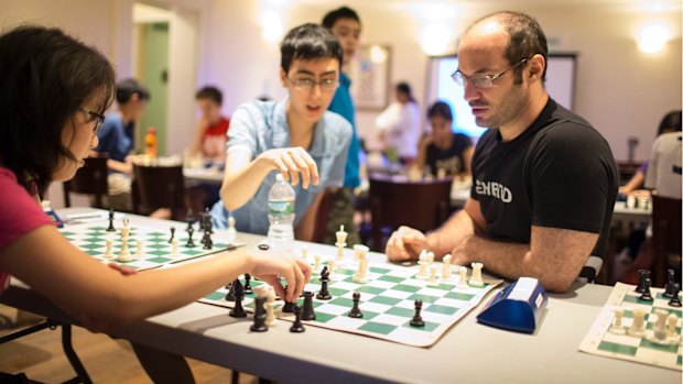 Greg Shahade, right, the instructor at the clinic at the Marshall Chess Club.