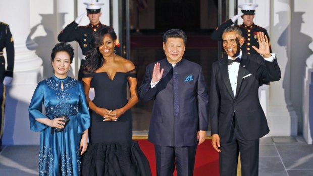 President Barack Obama, right, and Chinese President Xi Jinping, second from right, with wives Peng Liyuan, left, and first lady Michelle Obama as they arrive for a state dinner at the White House.