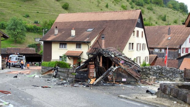 Parts of one of the two planes which crashed during an air show are seen in the village of Dittingen.