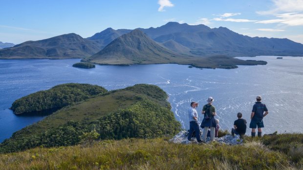 Guide Peter Marmion (L) with tourists from the Odalisque on top of Balmoral Hill, Port Davey.