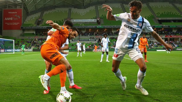 Brisbane's Jack Hingert (left) is pressured by City's James Brown. 