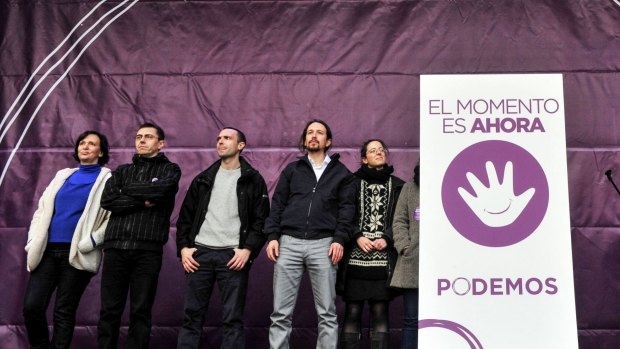 Podemos leaders on stage at the rally. The placard reads: "The moment is now - Podemos (We Can)".