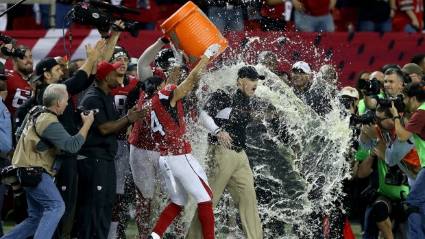 Falcons head coach Dan Quinn has gatorade dumped on him by his team late in the NFC Championship game against Green Bay. 