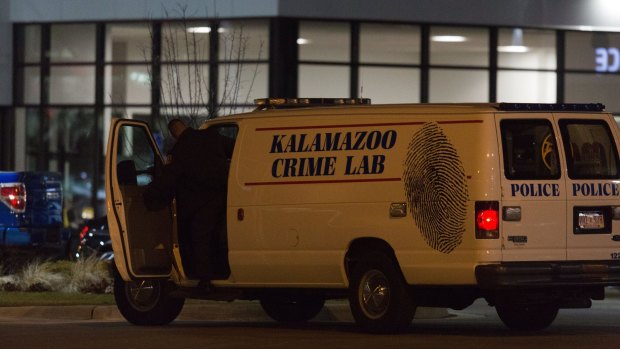 An officer with the Kalamazoo Crime Lab leaves the scene of one of the random shootings.