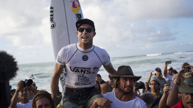 Hawaii triumph: Mick Fanning celebrates his victory at the Vans World Cup of Surfing at Sunset Beach on Oahu on Friday.