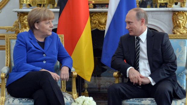 German Chancellor Angela Merkel and Russian President Vladimir Putin talk in Paris last year.