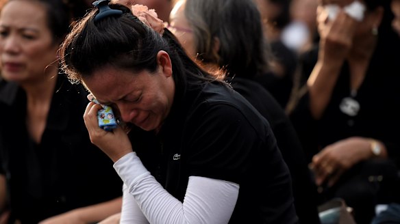 A woman weeps outside the Grand Palace in Bangkok.