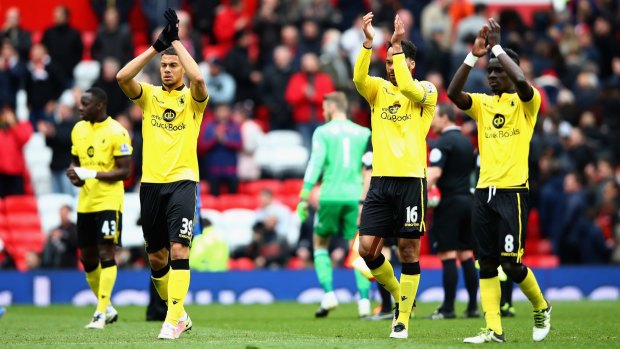 Solemn: Aston Villa players applaud the fans after his team was relegated following the Premier League match against Manchester United at Old Trafford.