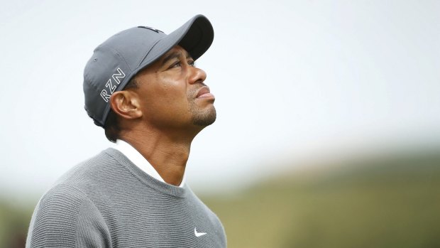 Tiger Woods walks onto the 16th green during the first round of the British Open golf championship.