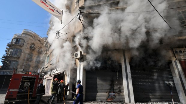 Lebanese firefighters tackle a blaze that broke out during clashes between the Lebanese army and Islamist gunmen.
