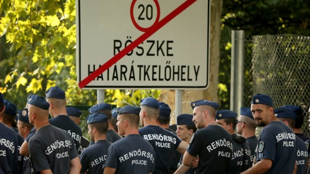 Police guard the closed Hungarian frontier crossing with Serbia near the village of Roszke Hungary.