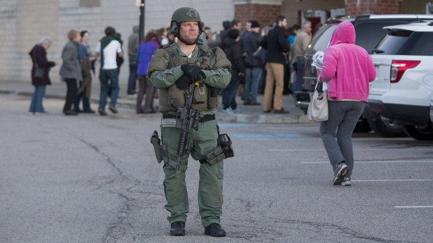 A member of the Metro-LEC SWAT team stands guard outside of a campaign rally for Bernie Sanders on Monday.