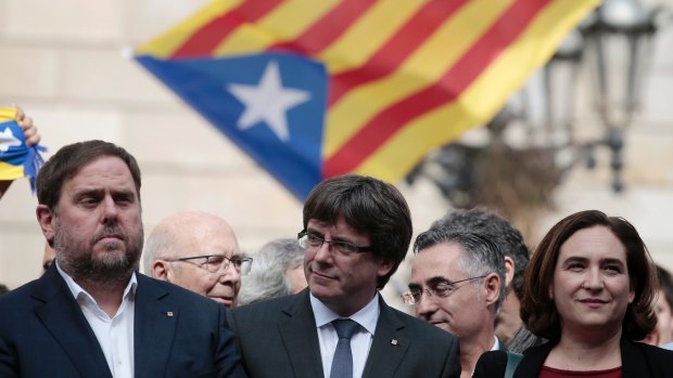 "I'm not surprised any more about what the Spanish government is doing": Catalan President Carles Puigdemont (centre).