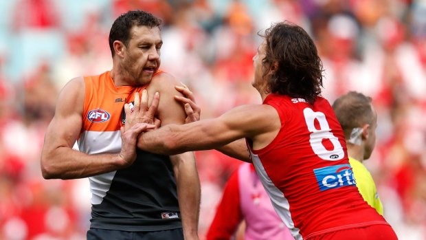 Fiery clash: Kurt Tippett and Shane Mumford wrestle during the 2016 AFL First Qualifying Final between the Sydney Swans and the GWS Giants at ANZ Stadium.